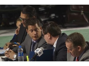 Vancouver Canucks scouting director Judd Brackett, at the 2018 NHL Entry Draft in Dallas, Texas. Bracket (second from left) is seated with Canucks GM Jim Benning, right,