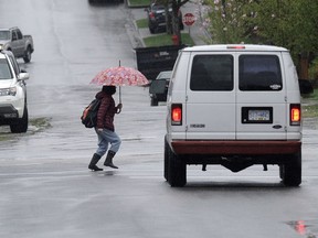 Pedestrians in the rain as City council considers reducing vehicle speeds in residential areas to 30km/h to reduce pedestrian crashes.