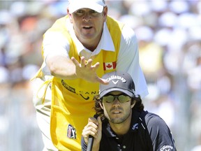 Adam Hadwin and caddie Brett Saunders, above, line up the Abbotsford golfer's putt during the third day of competition at the 2011 Canadian Open at the Shaughnessy Golf and Country Club in Vancouver.