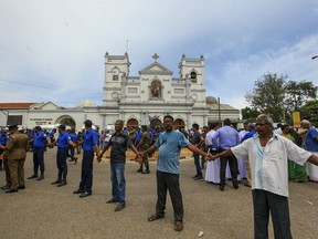 Sri Lankan army soldiers secure the area around St. Anthony's Shrine after a blast in Colombo, Sri Lanka, Sunday, April 21, 2019. More than hundred people were killed and hundreds more hospitalized from injuries in near simultaneous blasts that rocked three churches and three luxury hotels in Sri Lanka on Easter Sunday, a security official told The Associated Press, in the biggest violence in the South Asian country since its civil war ended a decade ago.