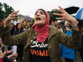 Linda Sarsour with Women's March calls out to other activists opposed to U.S. President Donald Trump's embattled Supreme Court nominee, Brett Kavanaugh, in front of the Supreme Court on Capitol Hill in Washington, Monday, Sept. 24, 2018.