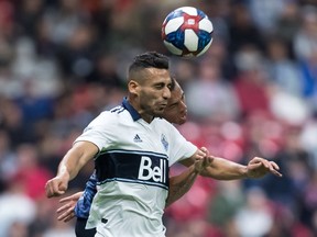 Ali Adnan of the Vancouver Whitecaps beats Los Angeles Galaxy's Rolf Feltscher to the ball during MLS action on April 5 at B.C. Place Stadium in Vancouver.