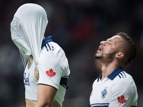 Vancouver Whitecaps' Joaquin Ardaiz, left, covers his head with his jersey as he and Lucas Venuto react after a missed scoring chance against the Los Angeles Galaxy on April 5.