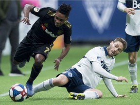 Vancouver Whitecaps midfielder Jon Erice (6) fights for control of the ball with Los Angeles FC forward Latif Blessing (7) during the first half of MLS soccer action in Vancouver, B.C. Wednesday, April 17, 2019.