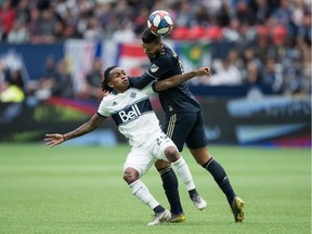 Vancouver Whitecaps' Yordy Reyna, left, and Philadelphia Union's Haris Medunjanin vie for the ball during the first half of an MLS soccer game in Vancouver, on Saturday April 27, 2019.