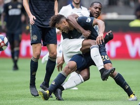 Philadelphia Union's Auston Trusty (26) defends against Vancouver Whitecaps' Doneil Henry during the second half of Saturday's game at B.C. Place Stadium.