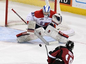 Vancouver forward Dawson Holt (19) scores the game-winning goal  in overtime of a WHL playoff game, Wed., April 24, 2019, in the Spokane Arena.