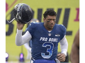 FILE - In this Jan. 27, 2019, file photo, NFC quarterback Russell Wilson of the Seattle Seahawks runs onto the field during player introductions before the NFL Pro Bowl football game against the AFC in Orlando, Fla. Wilson posted a video to social media early Tuesday, Apriil 16, 2019, saying, "Seattle, we got a deal," shortly after a reported midnight deadline for the Seahawks and their star quarterback to agree on a contract extension. Wilson's current $87.6 million, four-year deal was signed at the beginning of training camp in 2015 and was set to expire after next season.