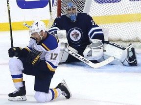 St. Louis Blues forward Jaden Schwartz (left) celebrates his game-winning goal past Winnipeg Jets goaltender Connor Hellebuyck during Game 5 of the first round of the NHL playoffs in Winnipeg on Thurs., April 18, 2019. Kevin King/Winnipeg Sun/Postmedia Network