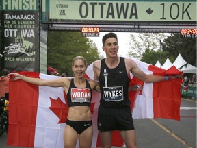 Natasha Wodak and Dylan Wykes celebrate after winning the Canadian 10k run at the Ottawa Race Weekend on Saturday, May 25, 2019.