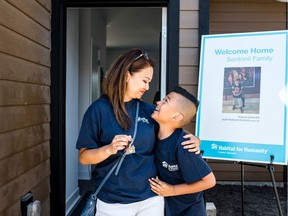 Rowena Santonil and her son, Justin Santonil, 9, receive the keys to their new home in Richmond. The home was built by Habitat for Humanity Greater Vancouver.