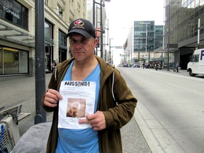 Dave M., a homeless man who didn't want his last name used, says his Alaskan Eskimo dog Cutiepie was stolen on Granville Street. He's holding a poster he is hoping will help him find his dog.