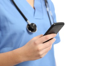 Close up of a nurse hand using a smart phone