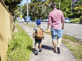 Father taking son to school. Parenting. Photo by Getty Images.