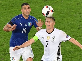 Italy's midfielder Stefano Sturaro (L) vies for the ball with Germany's midfielder Bastian Schweinsteiger during the Euro 2016 quarter-final football match between Germany and Italy at the Matmut Atlantique stadium in Bordeaux on July 2, 2016. Photo: Mehdi Fedouachmehdi/Getty