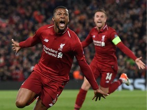 TOPSHOT - Liverpool's Dutch midfielder Georginio Wijnaldum celebrates after scoring their third goal during the UEFA Champions league semi-final second leg football match between Liverpool and Barcelona at Anfield in Liverpool, north west England on May 7, 2019.