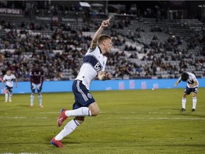 Vancouver Whitecaps midfielder Andy Rose (15) celebrates after scoring against the Colorado Rapids during the second half of an MLS soccer match Friday, May 3, 2019, in Commerce City, Colo.