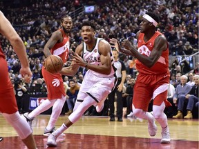 Milwaukee Bucks forward Giannis Antetokounmpo drives to the basket as Toronto Raptors forward Pascal Siakam (right) defends during a Jan. 31, 2019 NBA game in Toronto.