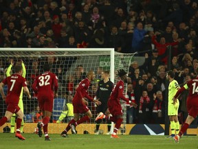 Liverpool's Divock Origi celebrates scoring his side's 4th goal during the Champions League semifinal, second leg, soccer match between Liverpool and FC Barcelona at the Anfield stadium in Liverpool, England, Tuesday, May 7, 2019.