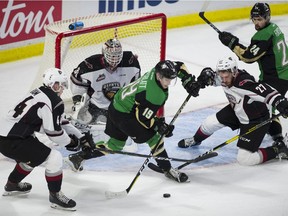 Prince Albert Raiders Cole Fonstad watches teammate Ozzy Wiesblatt hunt for the puck between Vancouver Giants Seth Bafard and Bowen Byram in front of goalie David Tendeck during WHL Championship series hockey at Langley Events Centre this week.