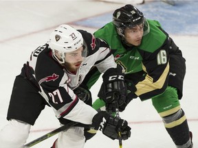 Vancouver Giants' Seth Bafard (left) and Prince Albert Raiders' Jakob Brook battle for position in the first period of Game 5 of their WHL Championship series at Langley Events Centre on Friday, May 10, 2019.