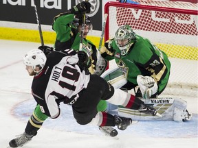 Prince Albert Raiders goalie Ian Scott watches teammate  Brayden Pachal clear Vancouver Giants Dawson Holt from in front of the net in game 4 of the Western Hockey League championship series playoffs at the Langley Event centre, Langley May 08 2019.