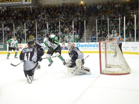 Prince Albert Raiders forward Parker Kelly jumps out of the way of a shot on Vancouver Giants goaltender David Tendeck as defenceman Alex Kannok Leipert watches during Game 6 on Sunday in Prince Albert.