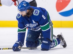Vancouver Canucks' Chris Tanev kneels on the ice after blocking a shot during the first period of an NHL hockey game against the New Jersey Devils in Vancouver, on Friday March 15, 2019. Tanev left the game and did not return to the ice. Photo: Darryl Dyck, CP