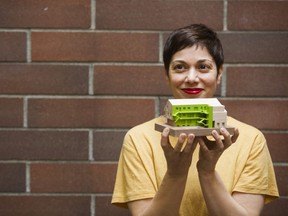 Marianne Amodio, an architect with MA+HG Architects, holds a model of Tomo House.