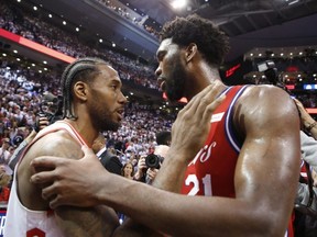 Raptors superstar Kawhi Leonard (left) is congratulated by Sixers’ Joel Embiid after Sunday night’s Toronto win.  JACK BOLAND/TORONTO SUN