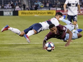 Fredy Montero of the Vancouver Whitecaps collides with Kellyn Acosta of the Colorado Rapids during Friday's MLS match at Dick's Sporting Goods Park in Commerce City, Colo.