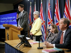 Minister of Finance Carole James and Attorney General David Eby release details in the most recent report on money-laundering in B.C., as chair of the expert panel Maureen Maloney and Peter German look on.