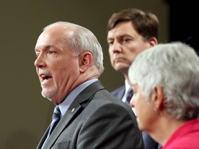 Premier John Horgan is joined by Finance Minister Carole James and Attorney General David Eby as they announce a public inquiry into money-laundering in the province during a newss conference at the B.C. legislature in Victoria on Wednesday.
