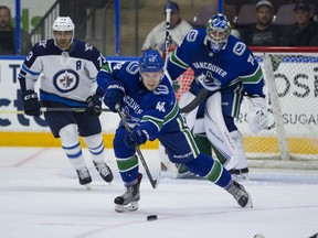 Vancouver Canucks' defenceman Olli Juolevi clears the puck against the Winnipeg Jets during the Young Stars Classic at the South Okanagan Events Centre in Penticton on Sept. 7, 2018