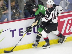 Vancouver Giants' Bowen Byram and Prince Albert Raiders' Jeremy Mastella fight for the puck during WHL Championship series playoff action at the Langley Events Centre on May 7.