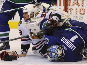 MAY 02, 2009: Vancouver Canucks Roberto Luongo and Chicago Blackhawks #33 Dustin Byfuglien end  tangled up in the crease during second period NHL playoff action.