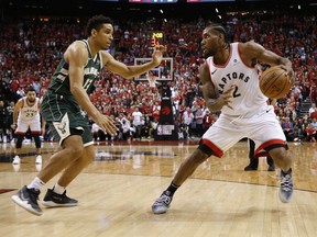 Milwaukee Bucks Malcolm Brogdon guards against Toronto Raptors Kawhi Leonard during fourth quarter in Toronto, Ont. on Sunday May 19, 2019. Jack Boland/Postmedia