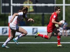 Team Canada's Ghislaine Landry, right, looks for an opening against Team England during quarter-final action at the HSBC Canada Women's Sevens at Westhills Stadium in Langford on Sunday, May 28, 2017.