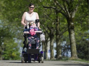 Cherie Ehlert and her daughter Charlie-Anne Cox enjoy the False Creek seawall. Charlie-Anne is entering the Scotiabank half-marathon in her wheelchair to raise money for a SMA cure. Photo: Gerry Kahrmann/Postmedia