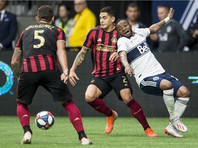 The Vancouver Whitecaps will be without forward Lass Bangoura, right, for Saturday's game against Sporting Kansas City. The speedy winger is out with a hamstring injury.