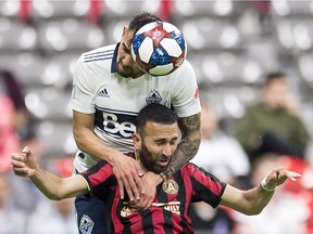 Vancouver Whitecaps defender Erik Godoy (22) vies for control of the ball with Atlanta United's Justin Meram during the first half of MLS soccer action in Vancouver, B.C., Wednesday, May, 15, 2019.