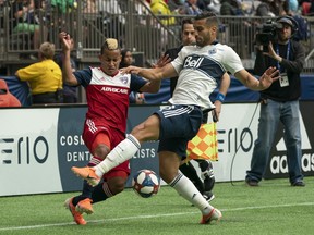 Vancouver Whitecaps' Ali Adnan (right) blocks the crossing attempt by Dallas FC's Michael Barrios during the first half of an MLS soccer game in Vancouver on Saturday, May 25, 2019.