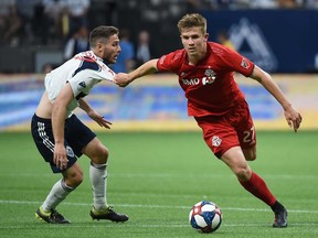 Toronto FC midfielder Liam Fraser puts the moves on Vancouver Whitecaps midfielder Jon Erice during Friday night's 1-1 draw at B.C. Place.
