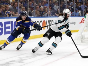 St. Louis Blues left wing Sammy Blais (9) tries to slow down San Jose Sharks defenseman Erik Karlsson (65), of Sweden, during the third period in Game 3 of the NHL hockey Stanley Cup Western Conference final series Wednesday, May 15, 2019, in St. Louis.