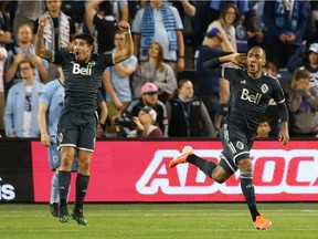 Whitecaps centre-back Derek Cornelius, right, celebrates his 94th-minute goal with teammate Joaquin Ardaiz to earn Vancouver a 1-1 draw with Sporting K.C. at Children's Mercy Park in Kansas City on Saturday, May 18, 2019.
