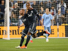 Whitecaps centre-back Derek Cornelius, right, celebrates his 94th-minute goal with teammate Lucas Venuto to earn Vancouver a 1-1 draw with Sporting K.C. at Children's Mercy Park in Kansas City on Saturday, May 18, 2019.