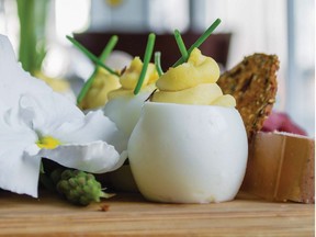 Cutting a small slice from the bottoms of hard-cooked eggs allows you to stand them upright, giving a fun, fresh look to your deviled eggs. Photo: Lisa Dawn Bolton