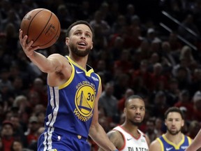 Golden State Warriors guard Stephen Curry (30) holds the ball after being whistled for a penalty during the first half of Game 4 of the NBA basketball playoffs Western Conference finals against the Portland Trail Blazers, Monday, May 20, 2019, in Portland, Ore.
