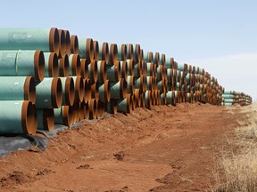 FILE - In this Feb. 1, 2012 file photo, miles of pipe ready to become part of the Keystone Pipeline are stacked in a field near Ripley, Okla. It was a nice story while it lasted. Moments from signing orders to advance the stalled Keystone XL and Dakota Access pipelines, President Donald Trump comes up with the idea of making the projects use pipes and steel made in the U.S. He inserts a little clause to that effect and vows the projects will only happen if his buy-American mandate is met. (AP Photo/Sue Ogrocki, File) ORG XMIT: WX108