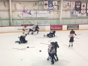 Members of the 13- and 14-year-old 2005 New Western Bruins, in white, from Langley and the 2005 Snipers from Nanaimo brawl at Planet Ice in Delta during a spring-hockey tournament recently.